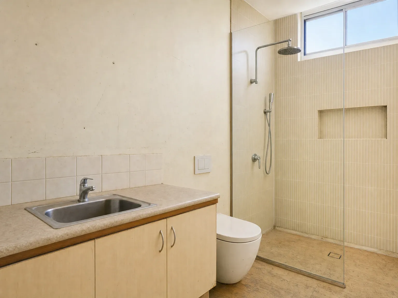 Tired Australian bathroom with dated finishes before a prompt-driven AI restyling edit