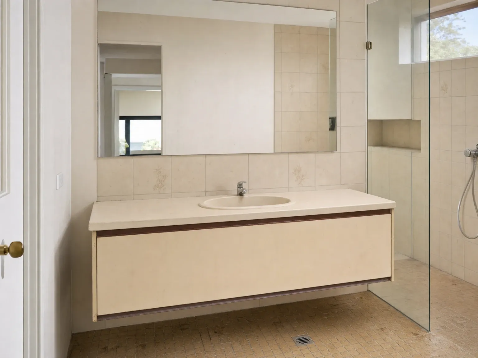 Dated Australian bathroom with laminate vanity before renovation