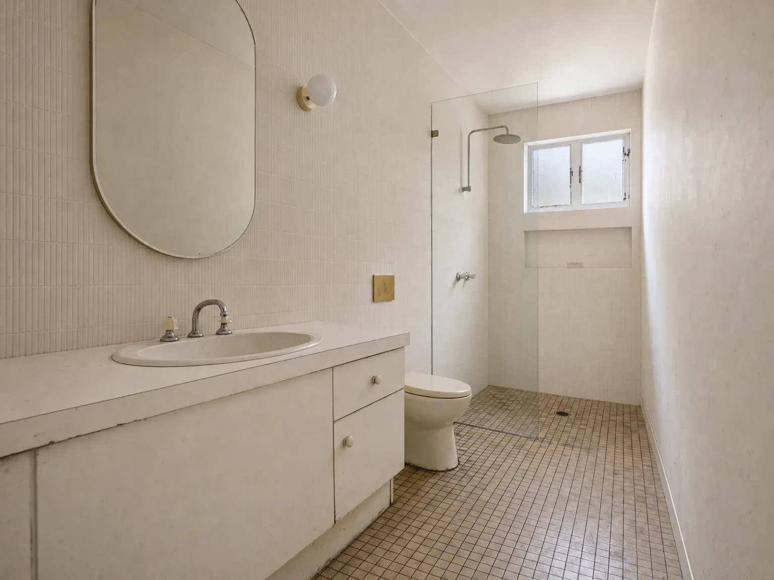 Dated Australian bathroom with poor layout and cramped fixture clearances