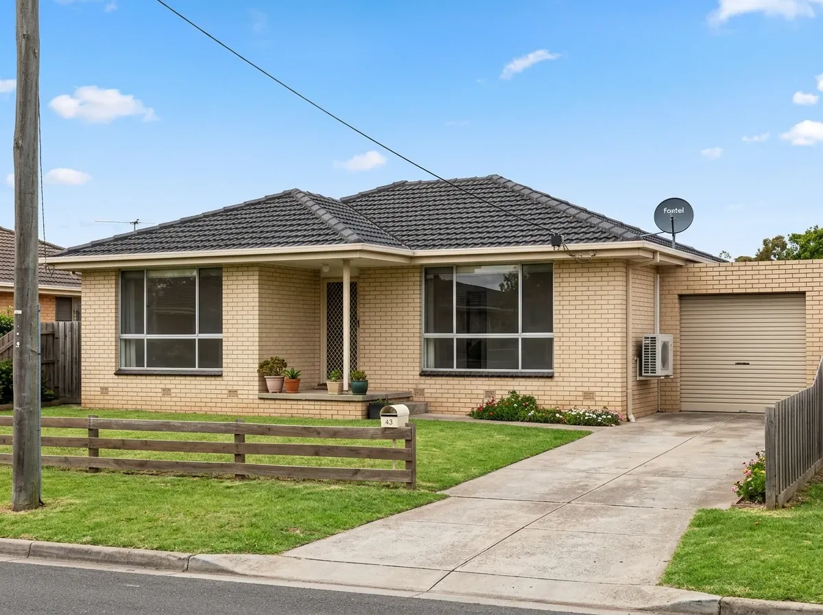 Typical Australian suburban home facade with overhead power line, wall-mounted air-conditioning condenser and roof satellite dish visible