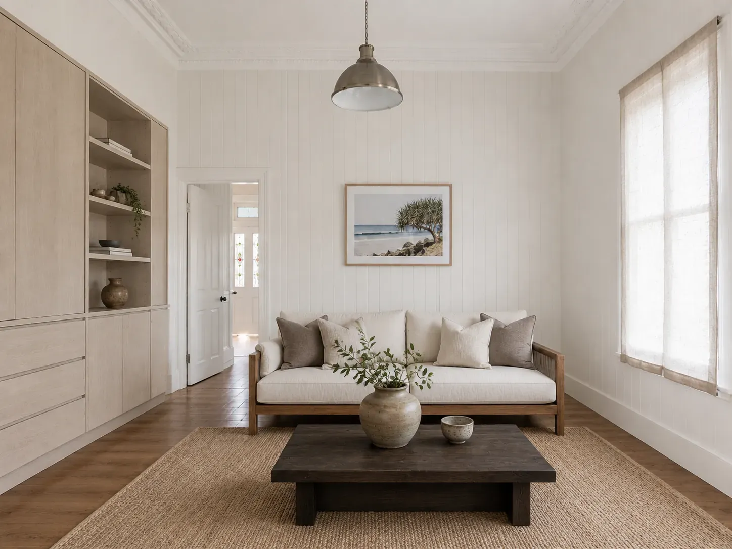 The same Queenslander interior restyled in Japandi with walnut floors, flat-front oak joinery and minimal linen furnishings