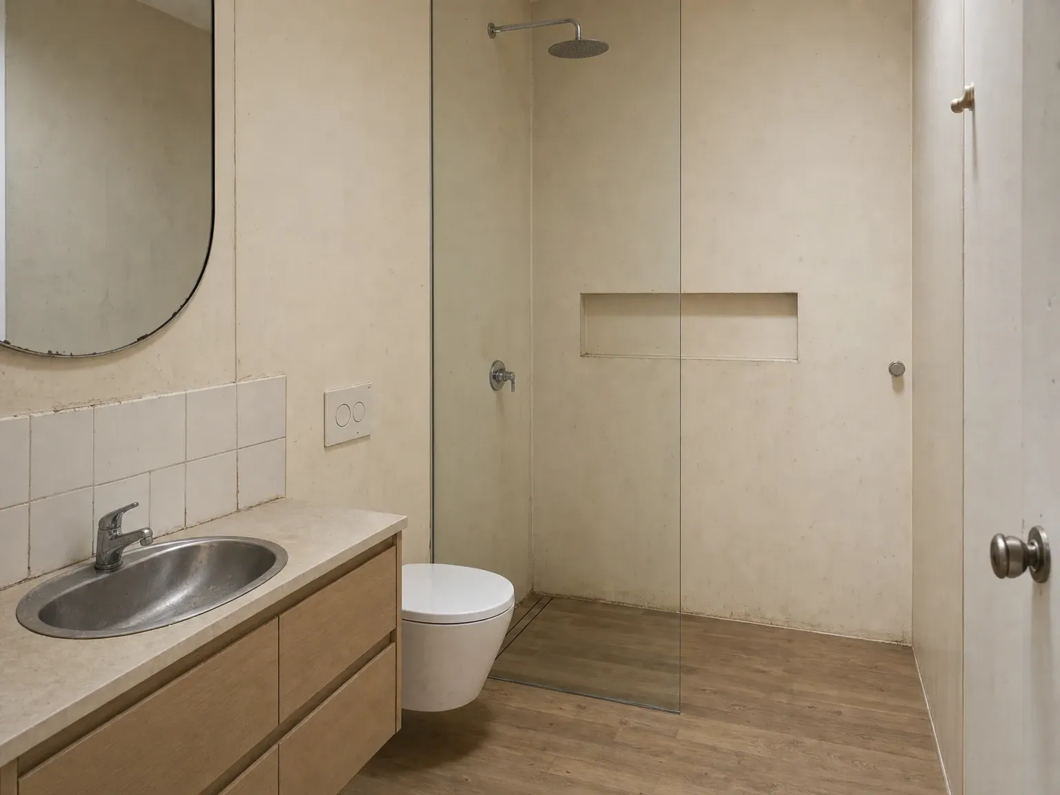 Compact Australian ensuite with dated cool-white tile and busy mid-wall feature stripe