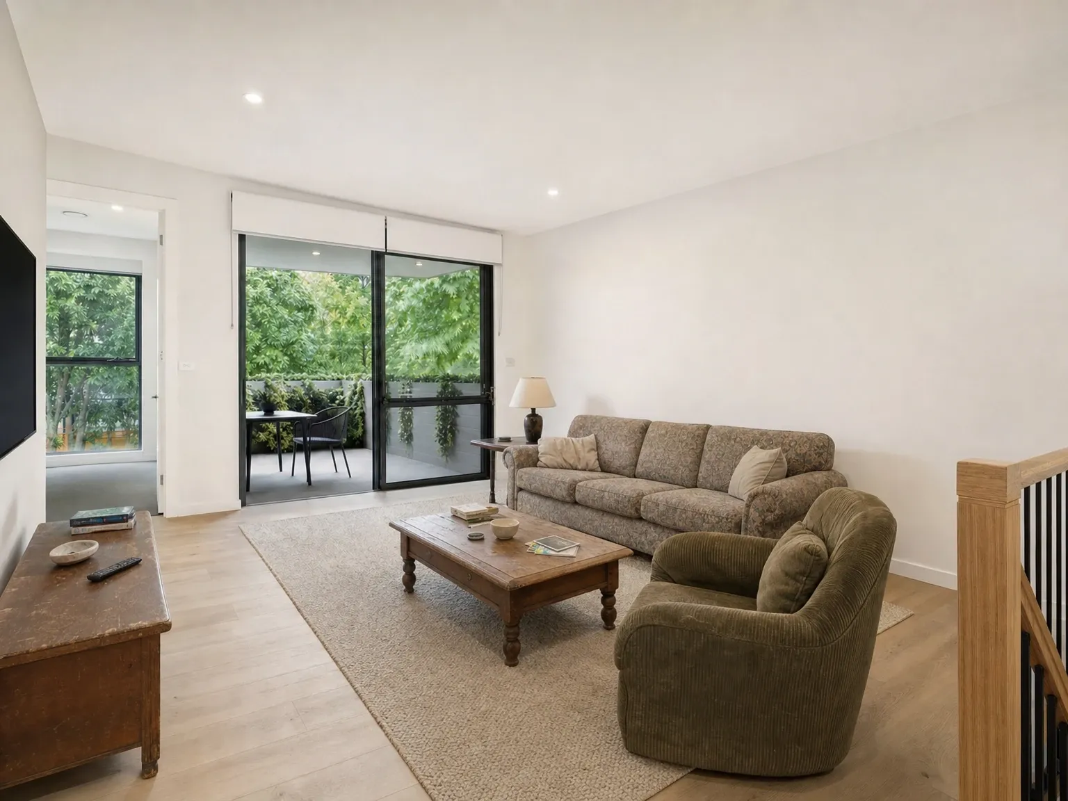 Tenant-occupied Australian living room with mismatched furniture and personal clutter before virtual decluttering